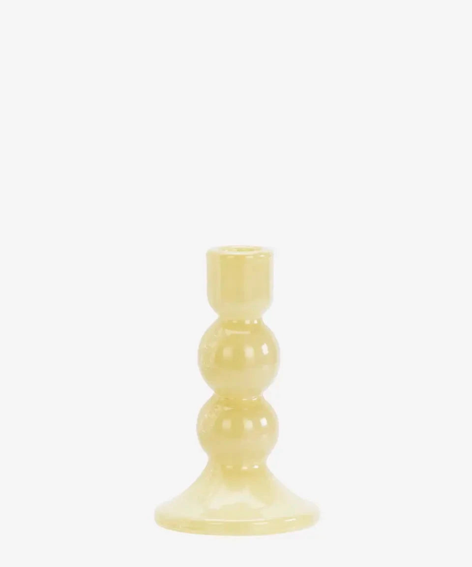 Yellow candle holder on a white background