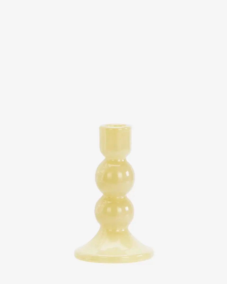 Yellow candle holder on a white background