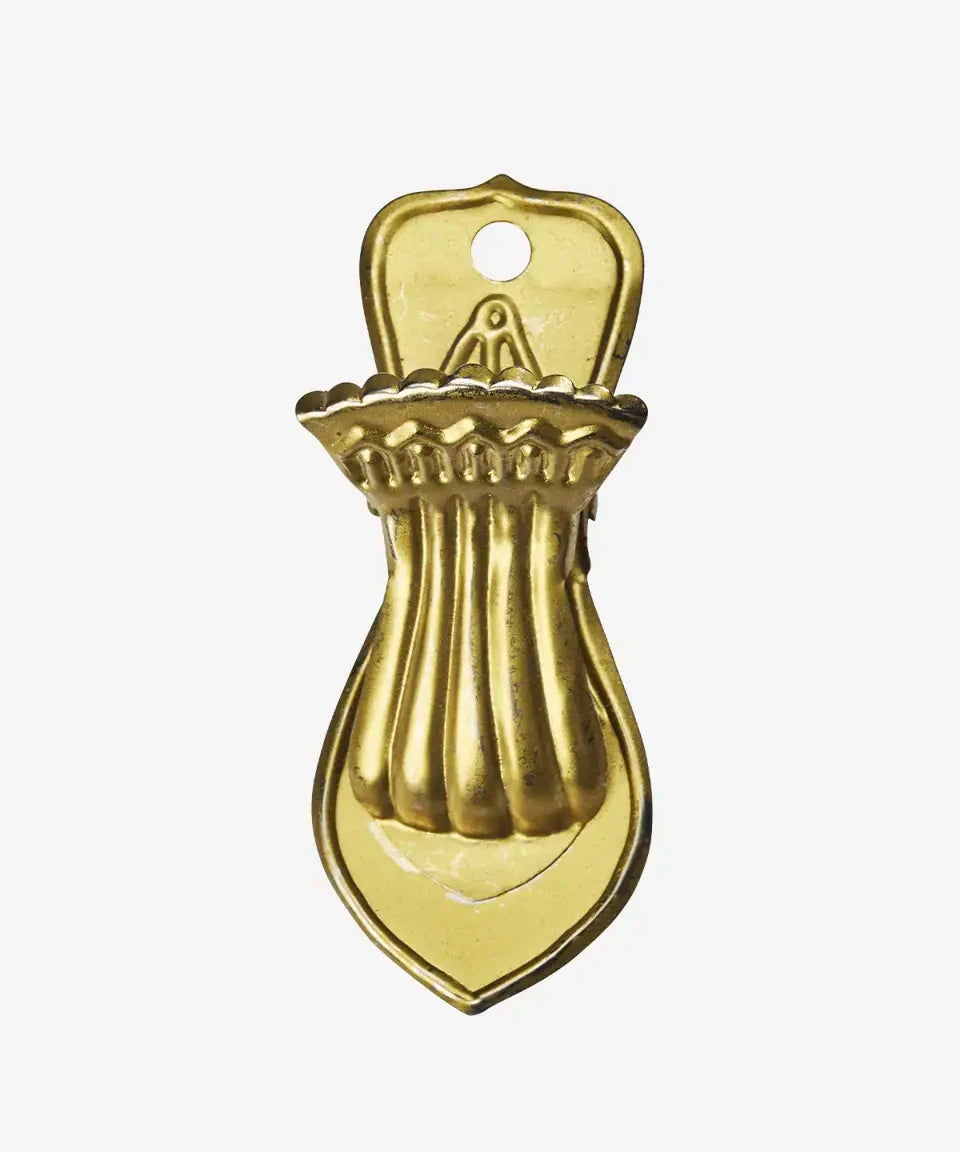 Gold bottle opener on a white background