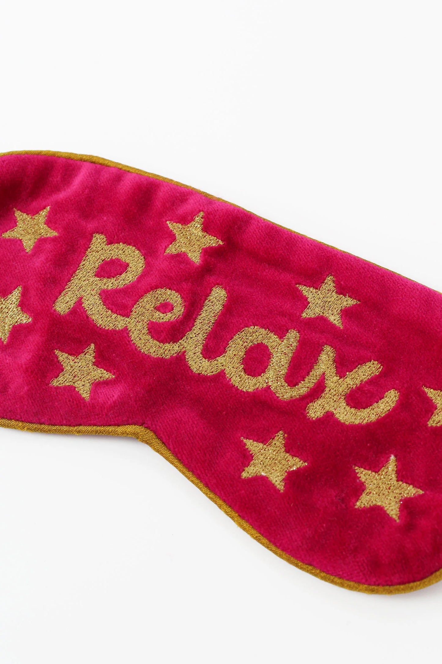 Close up of gold embroidered Relax sleep mask
