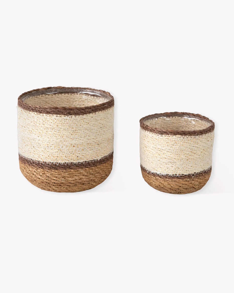 Two woven baskets with natural fiber design on a white background