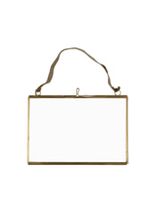 Gold rectangular frame with a string on a white background