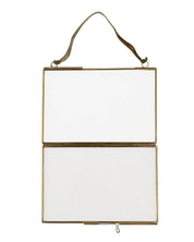 Hanging rectangular mirror with gold frame on a white background