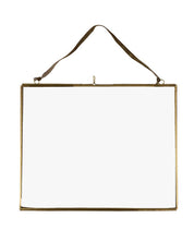 Gold rectangular picture frame with a leather strap on a white background