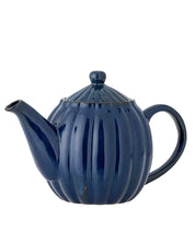 Blue ceramic teapot on a white background