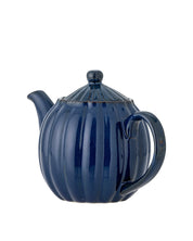 Blue ceramic teapot on a white background