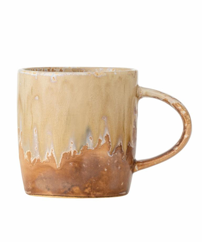 Beige ceramic mug with a textured surface on a white background