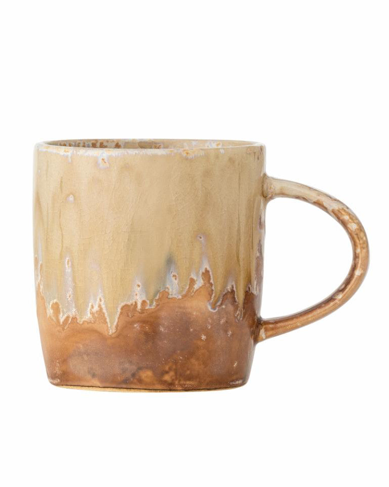 Beige ceramic mug with a textured surface on a white background