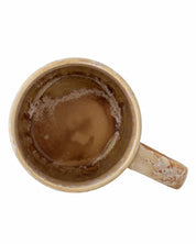 Brown ceramic mug with a handle on a white background