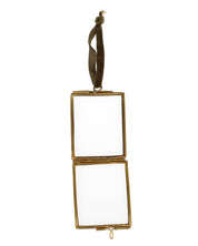 Gold rectangular mirror with ribbon on a white background