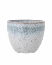 Speckled ceramic pot on a white background