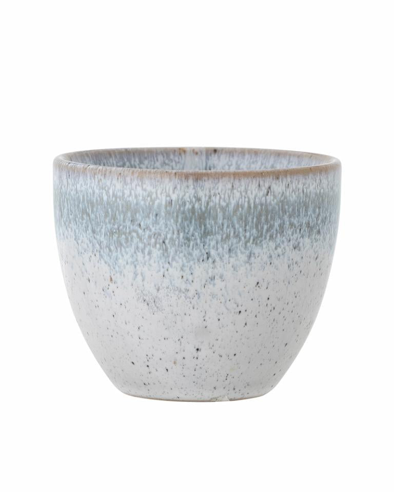 Speckled ceramic pot on a white background