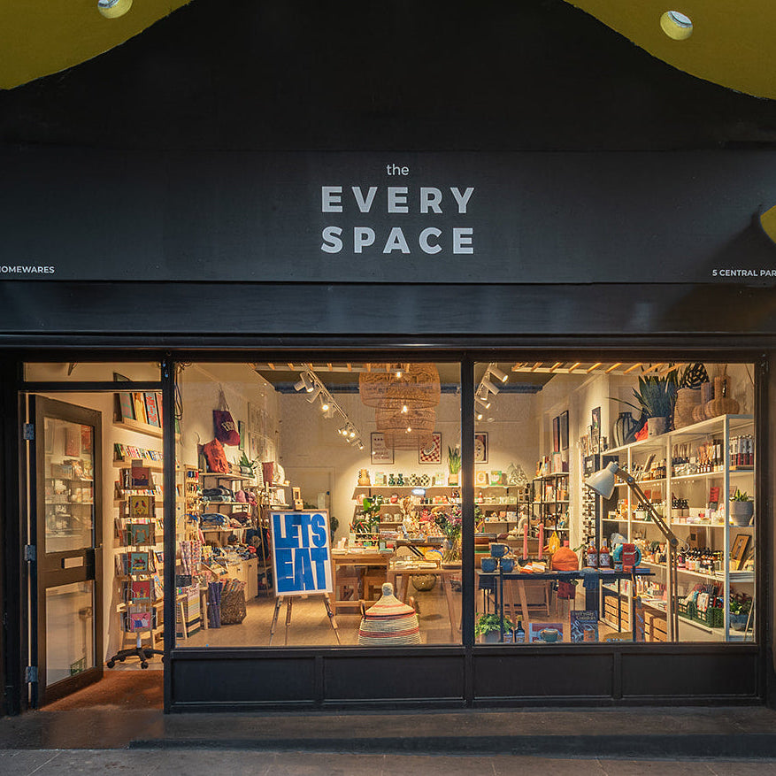 Storefront of 'the EVERY SPACE' with glass windows displaying interior.