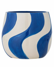 Ceramic vase with blue and white wave pattern on a white background