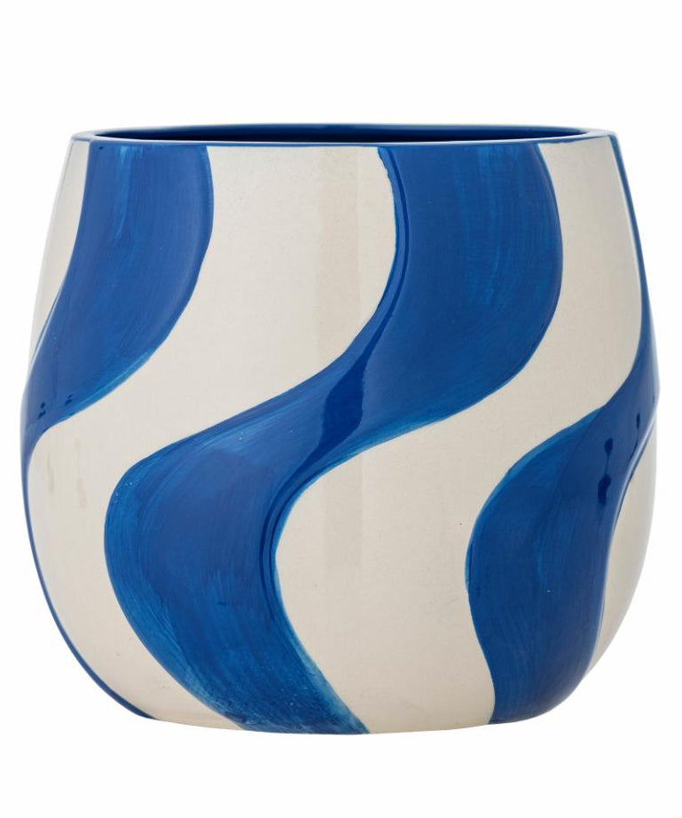 Ceramic vase with blue and white wave pattern on a white background