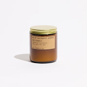 Saltwater Jasmine candle, by PF Candle Co, in an amber glass jar with a brass lid, against. a white background