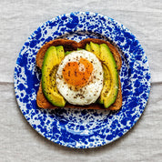 Crow Canyon Home splatter enamelware salad plate, in blue, with avocado on toast
