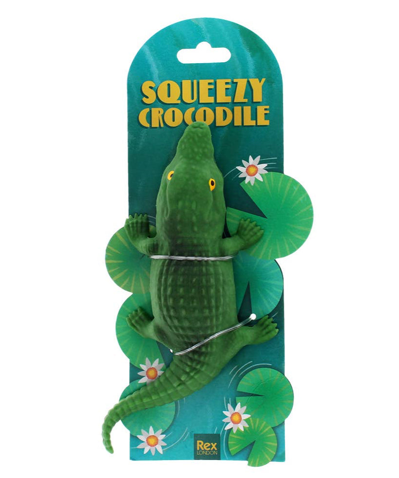 Green crocodile toy with packaging labeled 'Squeezy Crocodile' on a white background