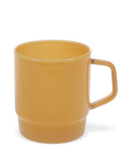 Yellow mug on a white background