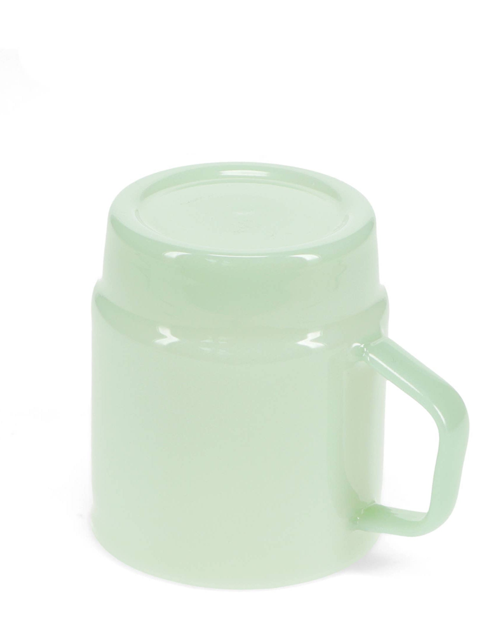 Light green mug with handle on a white background