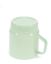 Light green mug with handle on a white background