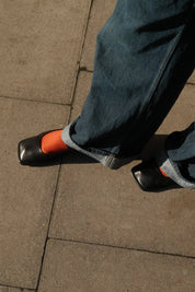 Lady wearing the waffle rust socks with black pump shoes