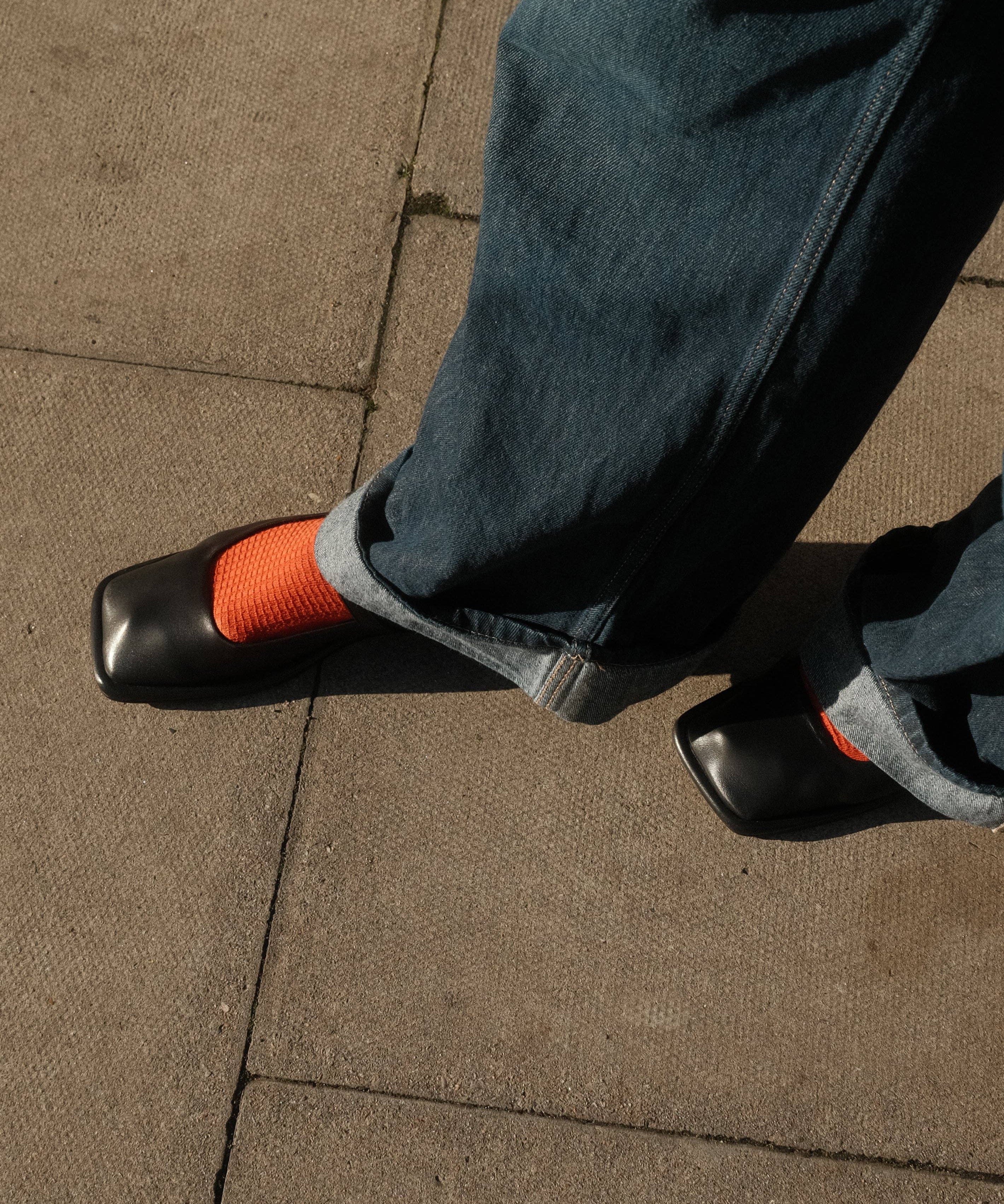 Lady wearing the waffle rust socks with black pump shoes