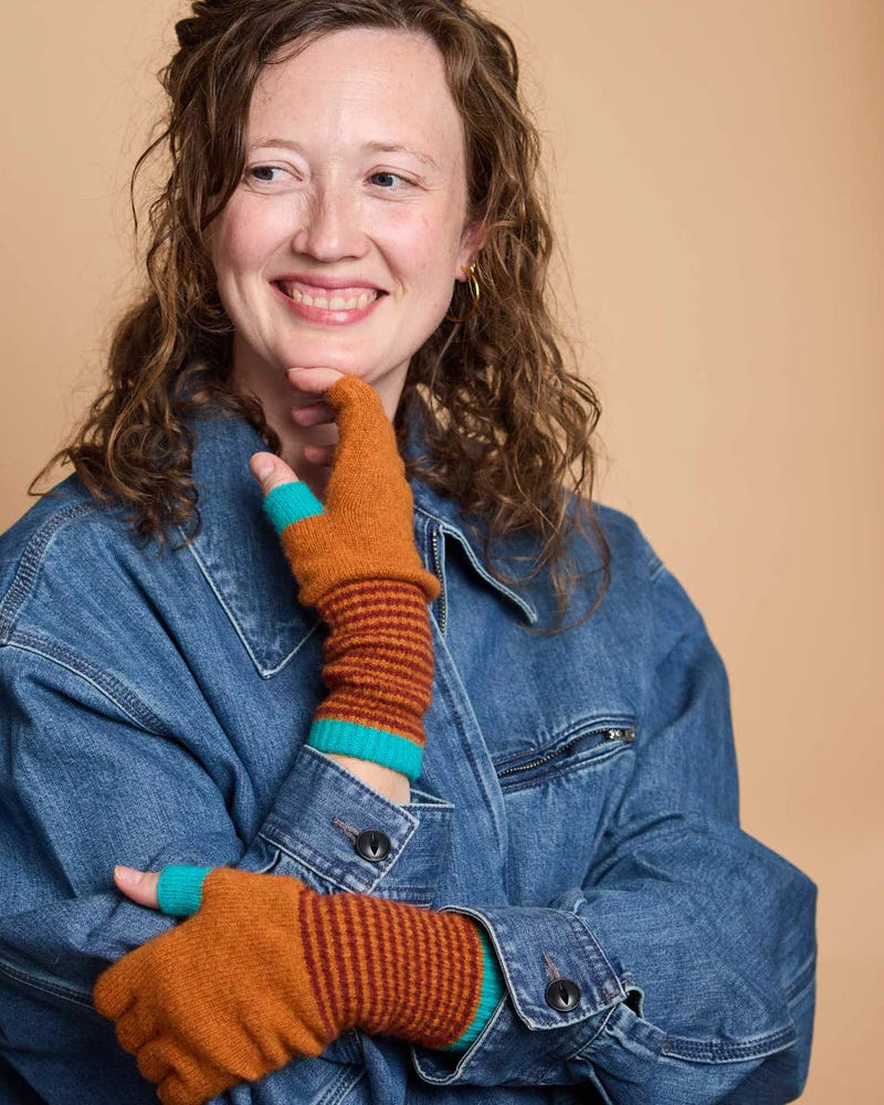 Woman wearing Catherine Tough fingerless lambswool gloves while typing