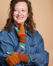 Woman wearing Catherine Tough fingerless lambswool gloves while typing