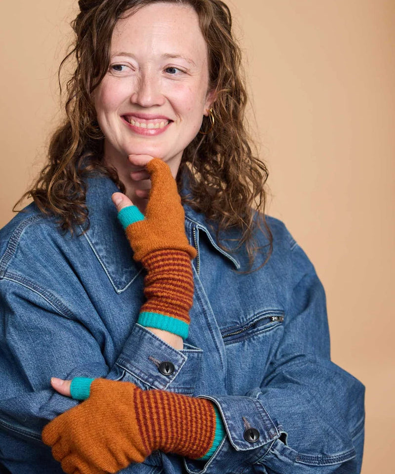 Woman wearing Catherine Tough fingerless lambswool gloves while typing