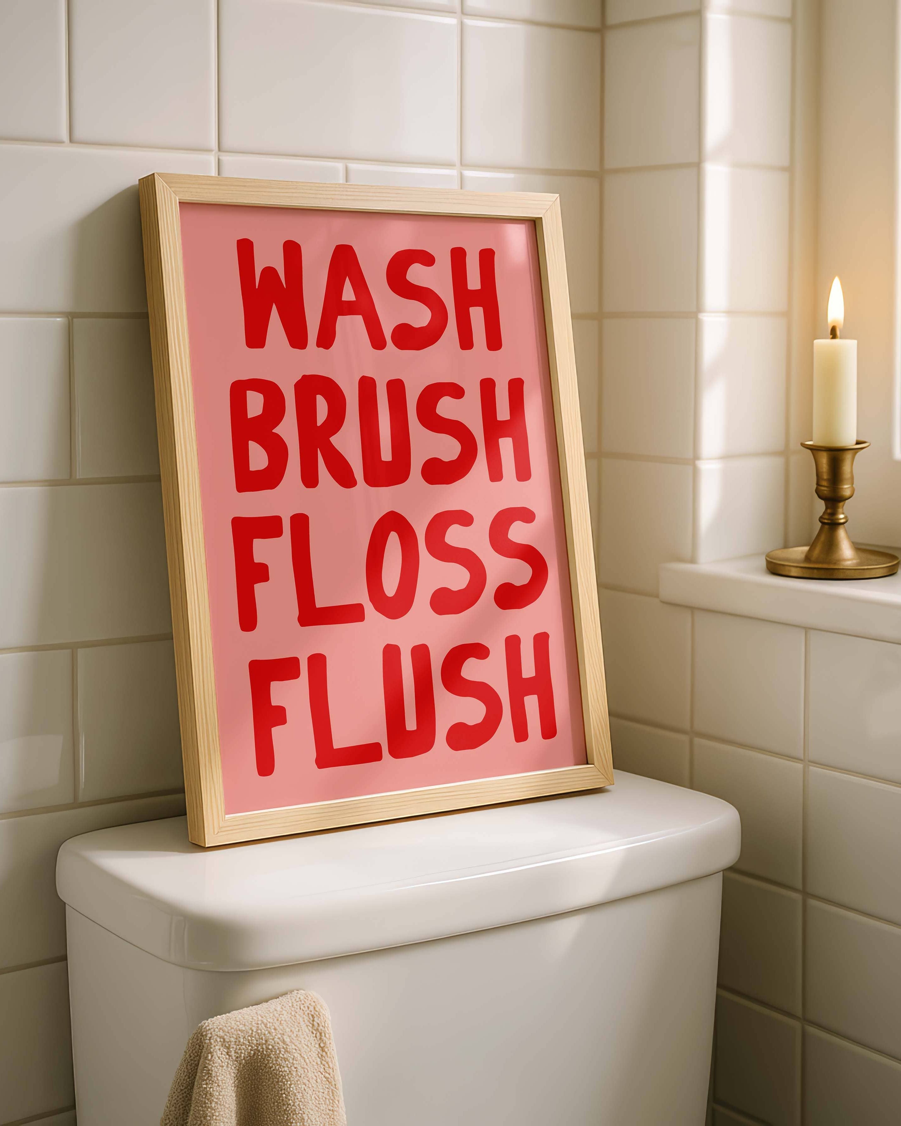 Bathroom with a framed sign on a toilet tank reading 'WASH BRUSH FLOSS FLUSH'.