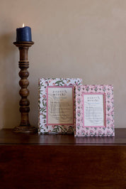 Floral patterned picture frame made from recycled cotton paper, sitting on a wooden table