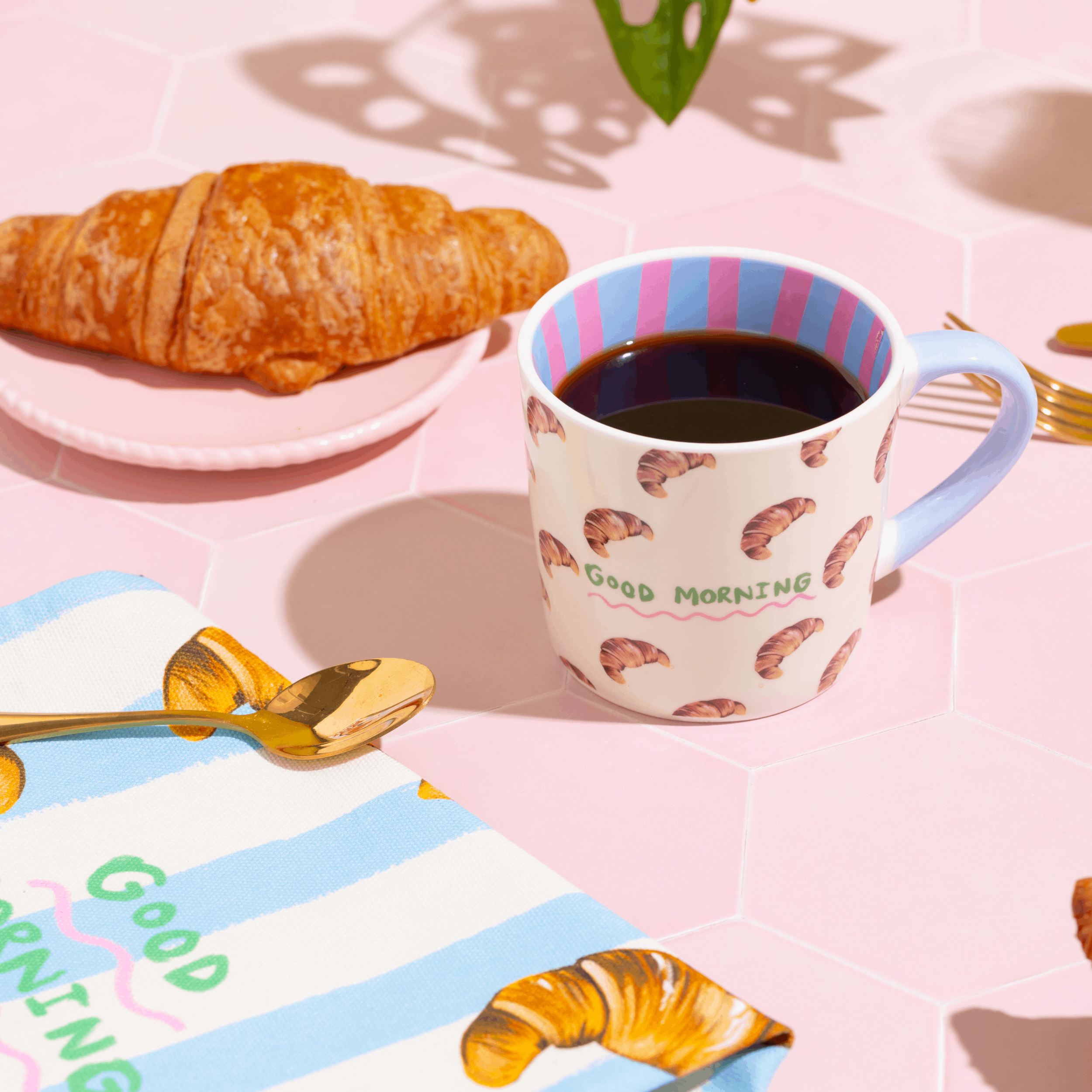 Mug with croissant pattern and 'Good Morning' text by Eleanor Bowmer.
