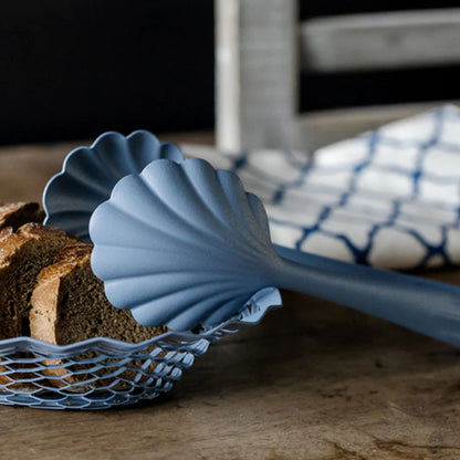 The Every Space scalloped, vintage pastel blue Bread Tongs in stainless steel with a matt finish by Roger Orfevre