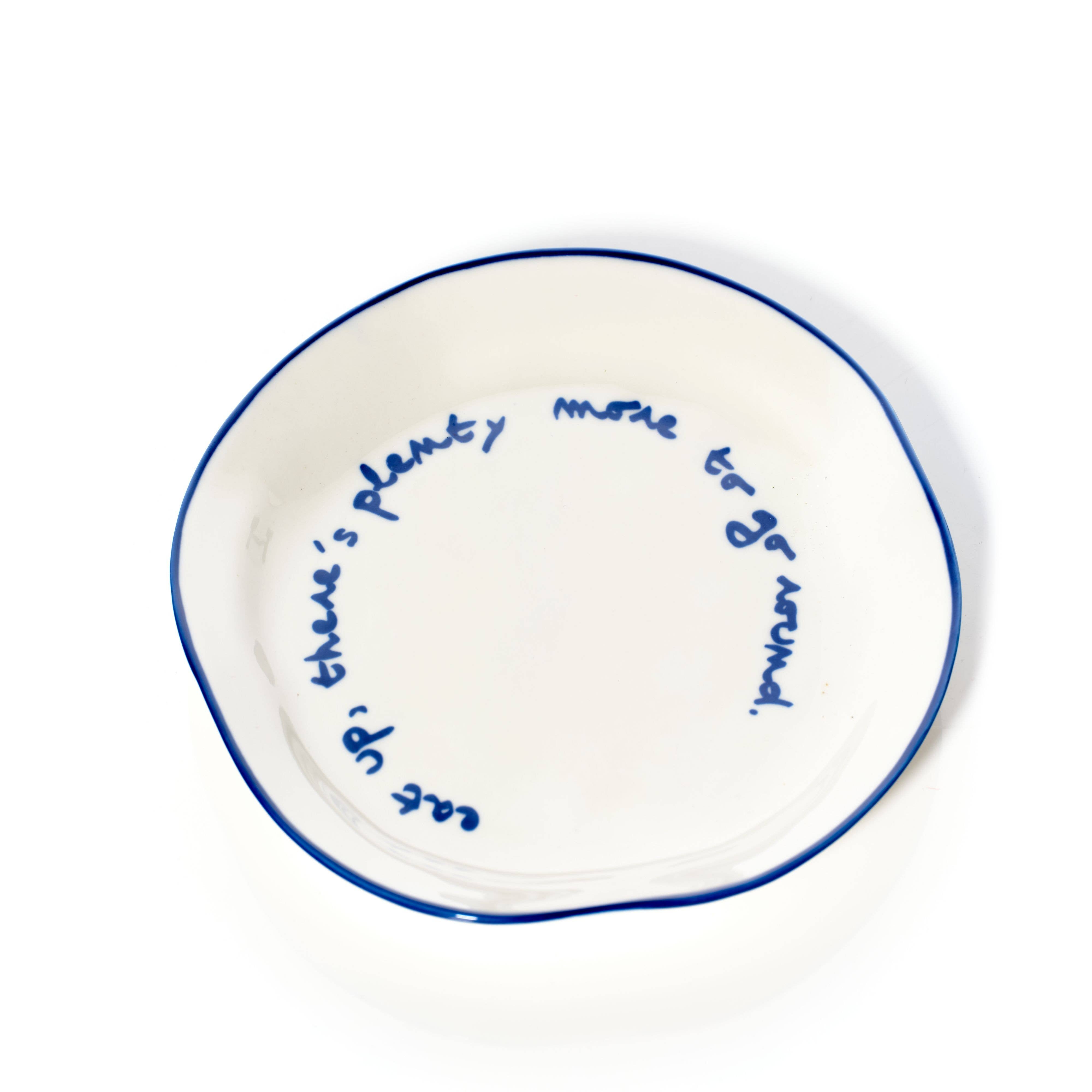 White plate with blue rim and blue text 'eat up, there's plenty to go round'