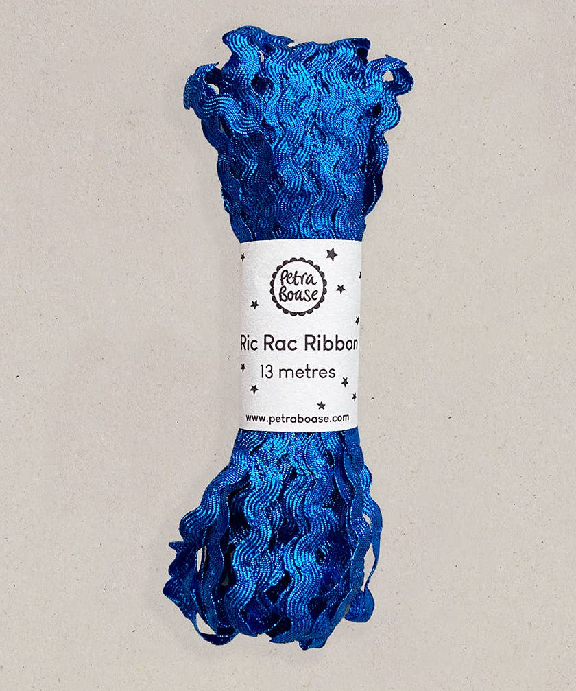 Blue ric rac ribbon on a beige background with a label