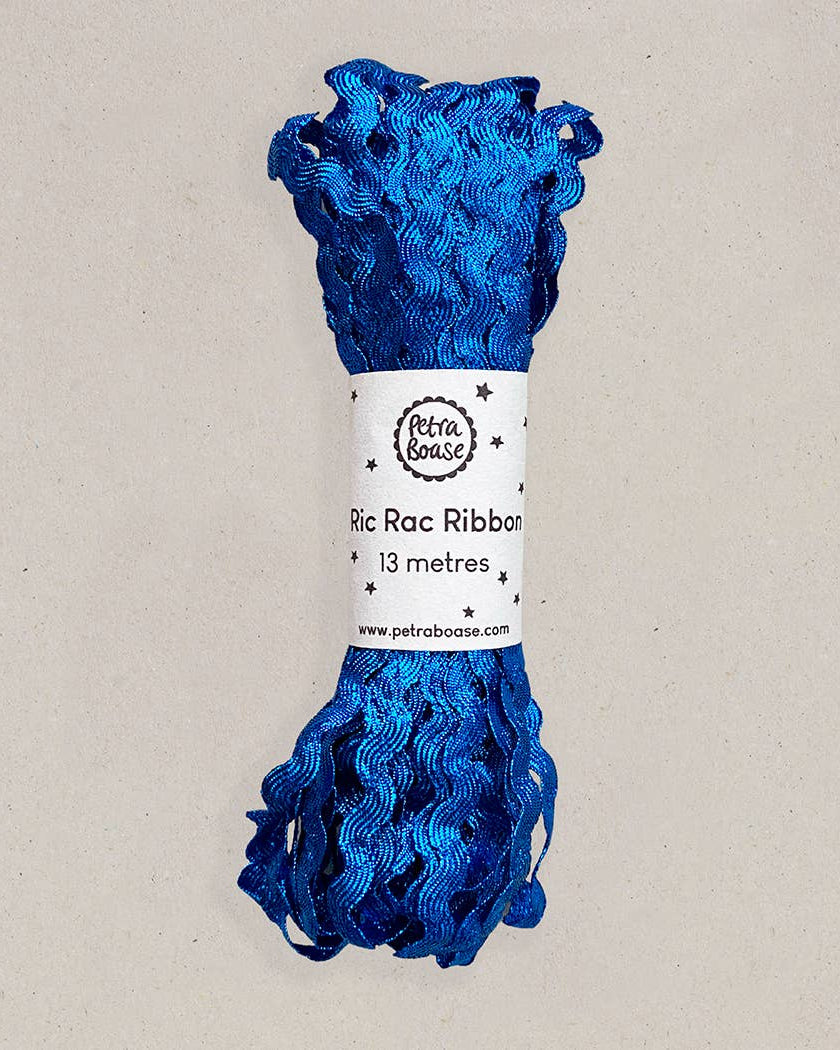 Blue ric rac ribbon on a beige background with a label