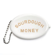 White oval rubber money purse keyring with 'Sourdough Money' text in beige and metal chain