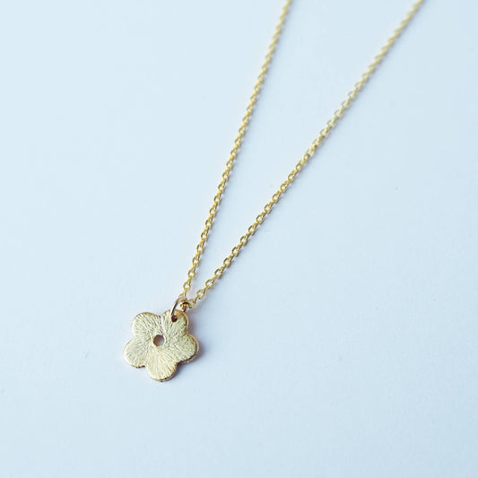 a beautiful gold flower-like necklace 