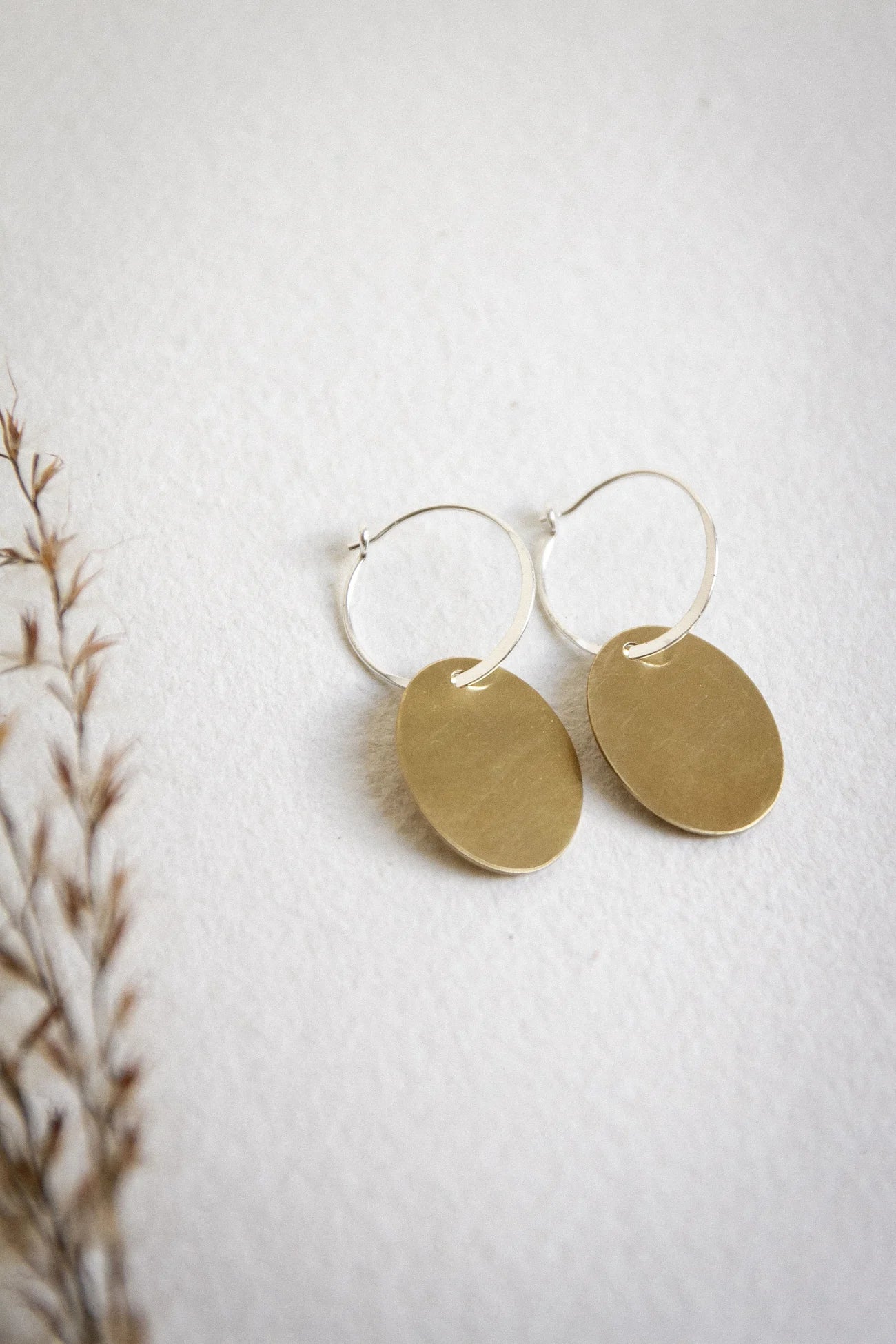 The Every Space handmade recycled brass hoop oval drop earrings with sterling silver hoops by Clare Elizabeth Kilgour