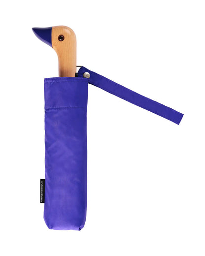 The Every Space compact, eco-friendly and lightweight, Royal Blue Umbrella, with 100% recycled, wind resistant fabric on a high-strength steel frame, sustainably sourced birch handle made from one solid piece of wood, and automatic open button, by Original Duckhead.