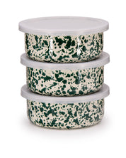 Stack of three green and white speckled bowls with lids on a white background