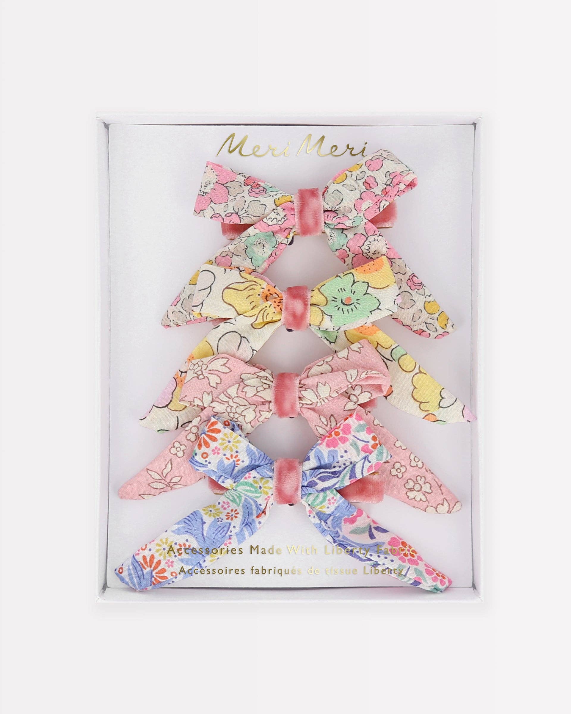 Set of floral hair bows in a branded box on a white background
