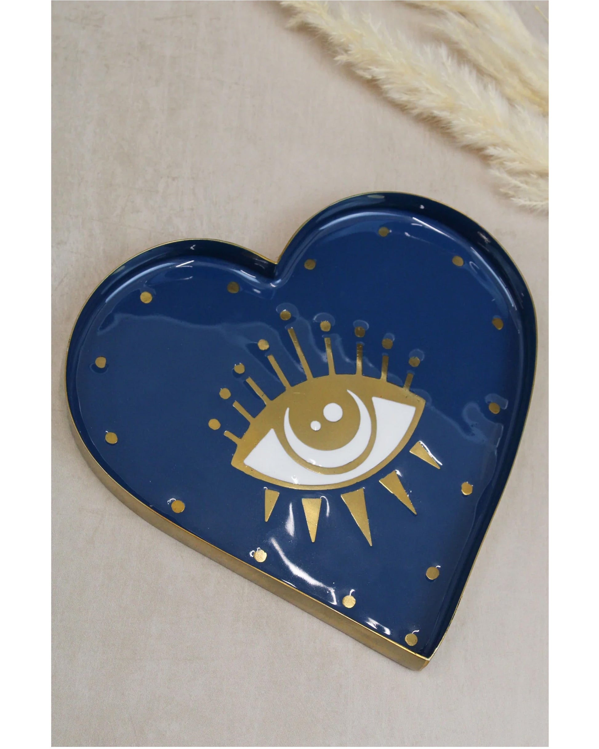 The Every Space brass and hand-enamelled heart-shaped Eye Trinket Dish with a gold eye motif by My Doris