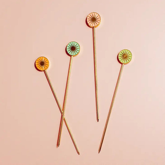 Set of 4 gold metal cocktail picks, by Cai & Jo, has pastel coloured sun heads and comes packaged in a gift box.