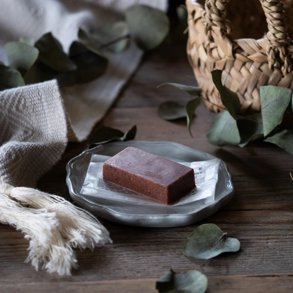 Yellow Gorse pink clay facial exfoliating bar on a plate