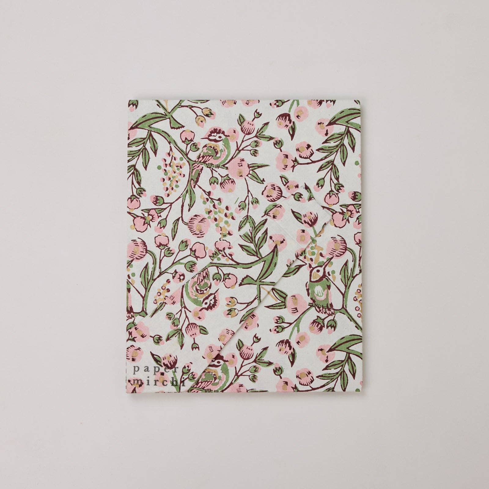 The back of a floral patterned picture frame made from recycled cotton paper, on a white background