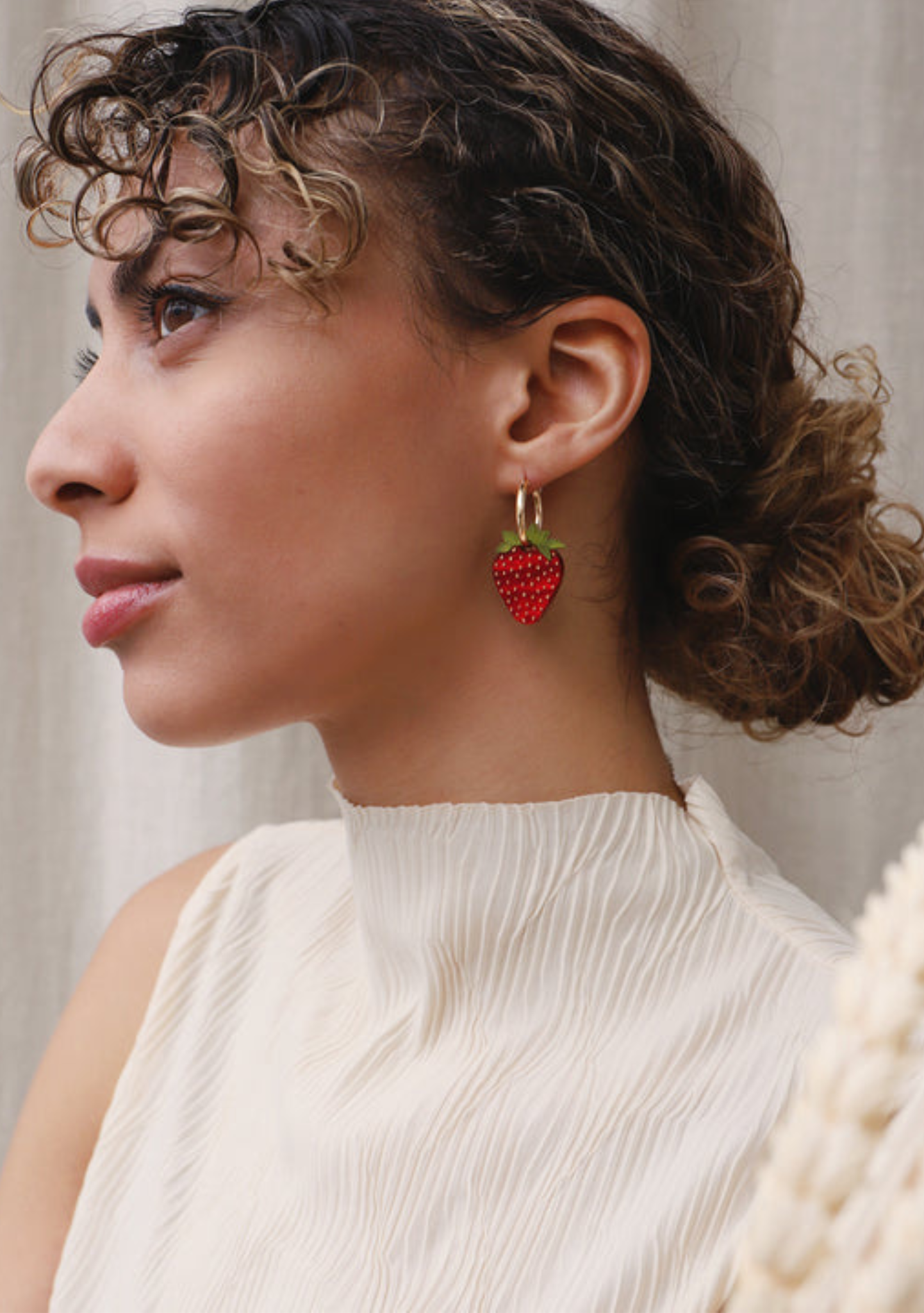 model wearing acrylic strawberry charm hoops by wolf and moon