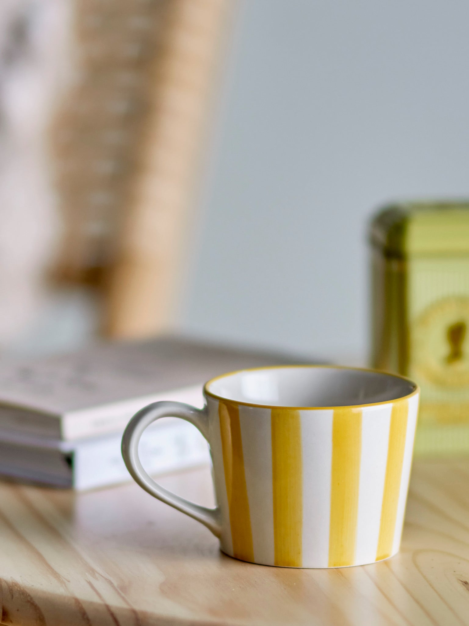 The Every Space stoneware Begonia Mug handpainted with yellow stripes by Bloomingville
