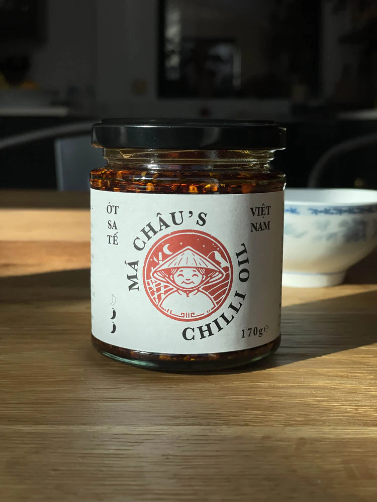 Jar of Mâ Cháu's Chilli Oil on a wooden surface